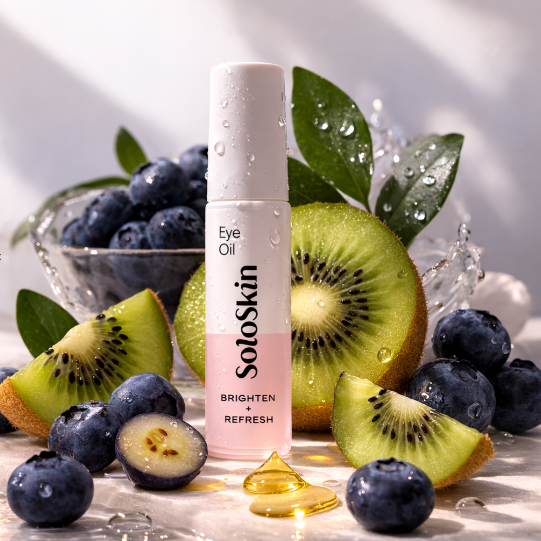 SoloSkin Eye Oil bottle with kiwis and blueberries on a reflective surface