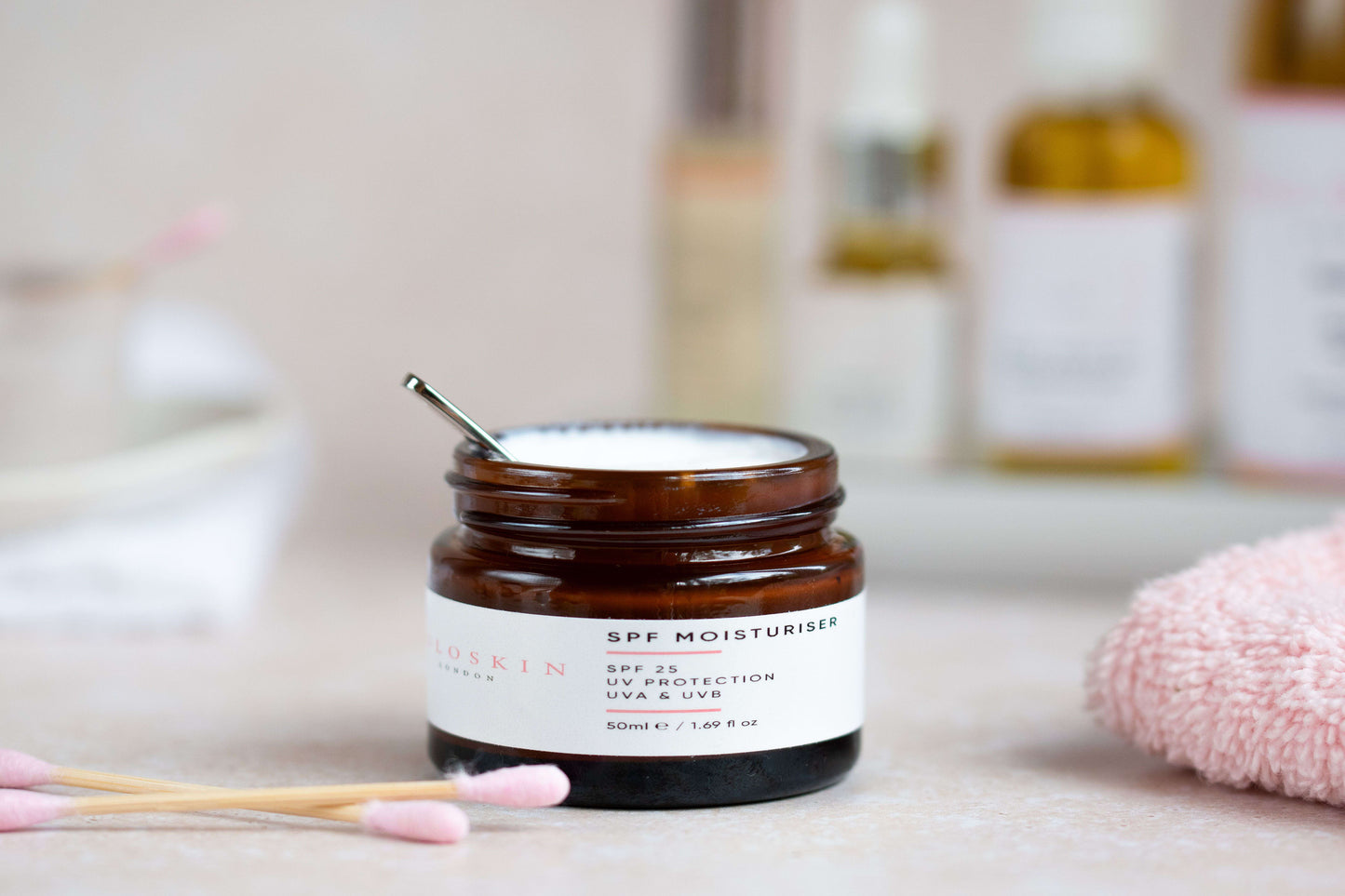 Jar of skincare product with a brush on a bathroom counter