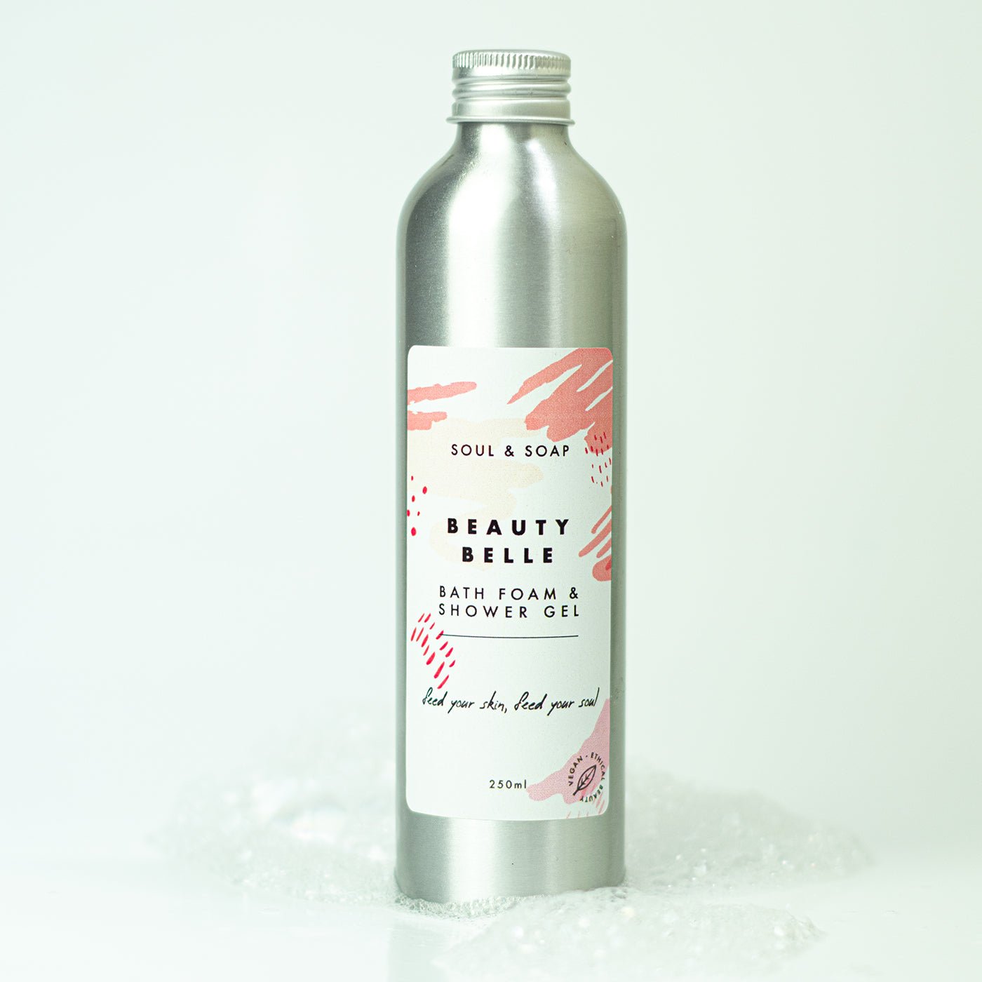 Silver bottle of Beauty Belle bath foam and shower gel with a white label on a white background.