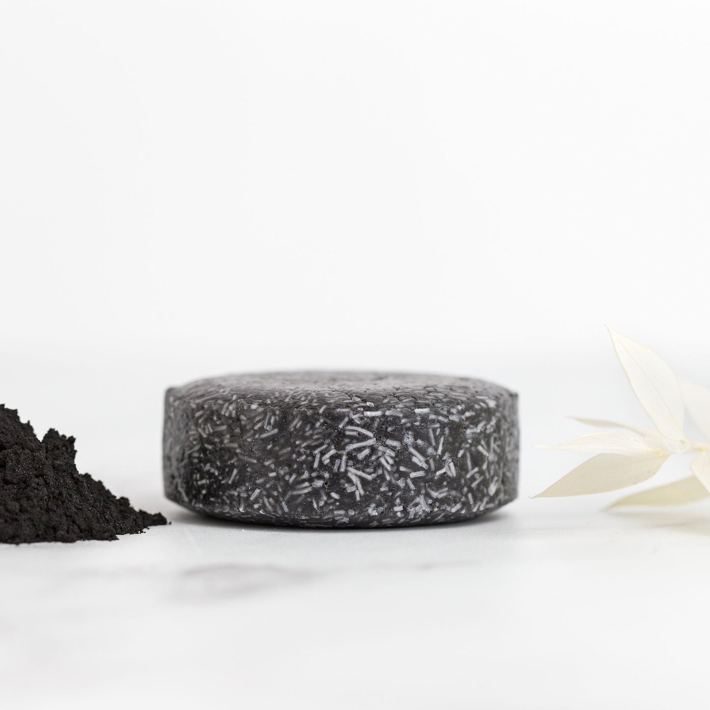Black textured soap bar on a white background