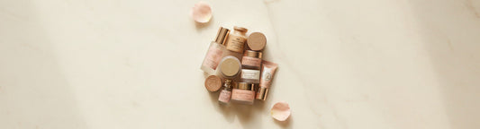 A group of random beauty products on a marble background, being used as the header image for a blog article called Your August Treat Guide: Every Voucher Code Live at The Salon Look