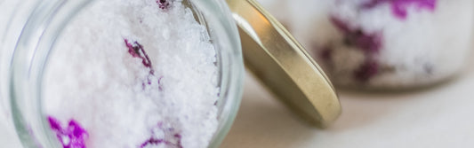 Bath salts in a glass jar, styled for a home spa