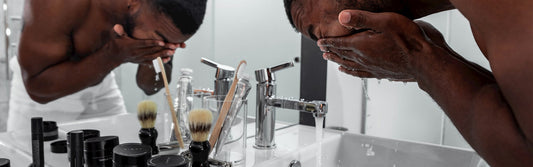 Man at a bathroom sink beginning his daily skincare and grooming routine