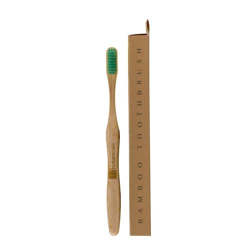 Bamboo toothbrush with green bristles and packaging on a white background