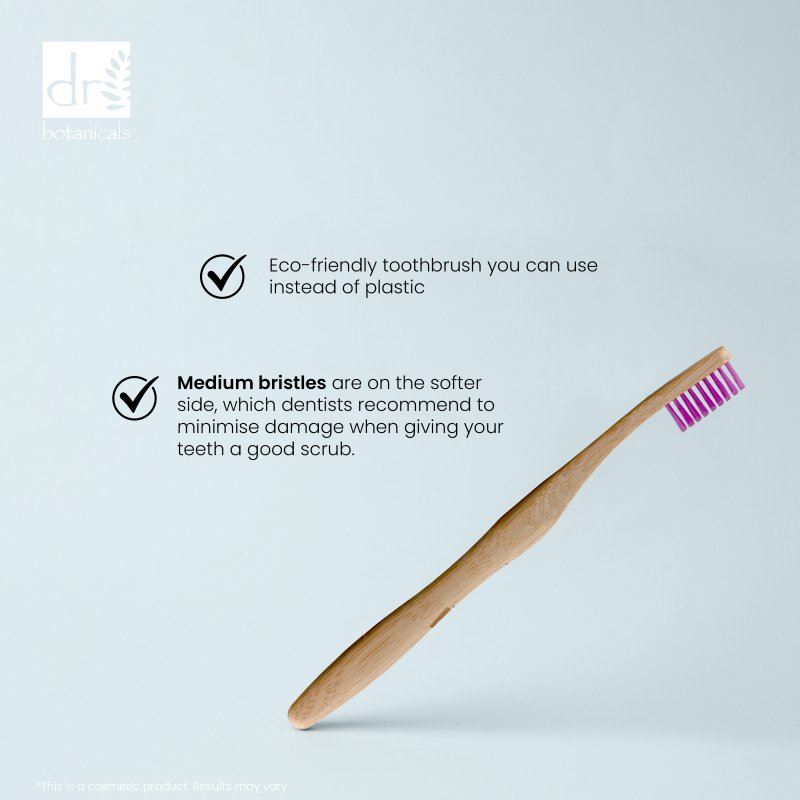 Eco-friendly toothbrush with purple bristles on a light blue background