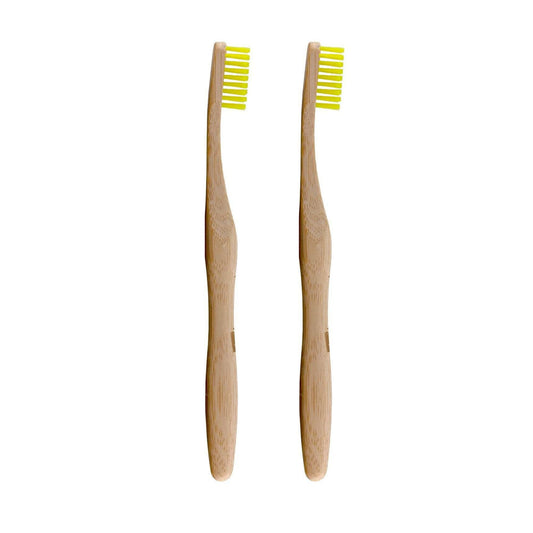 Two bamboo toothbrushes with yellow bristles on a white background