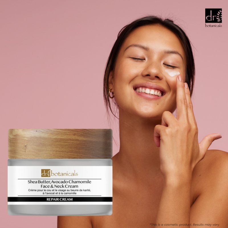 Woman applying cream to her face with a jar of Dr. Botanicals cream on a pink background