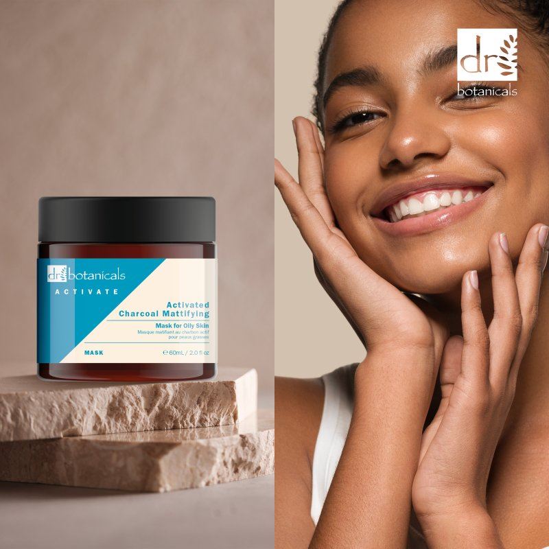 Dr Botanicals jar of activated charcoal mask with a woman touching her face on a beige background