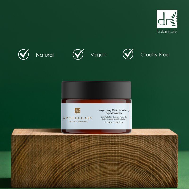 Jar of Apothecary skincare product on a wooden block with Dr Botanicals branding and certification icons.