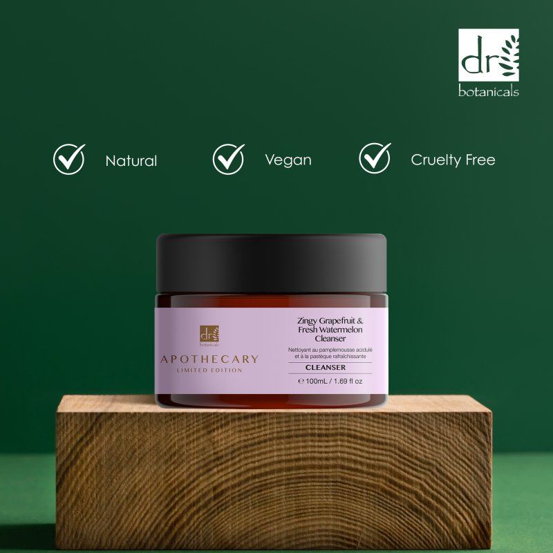 Jar of Dr Botanicals Apothecary cleaner on a wooden block with green background