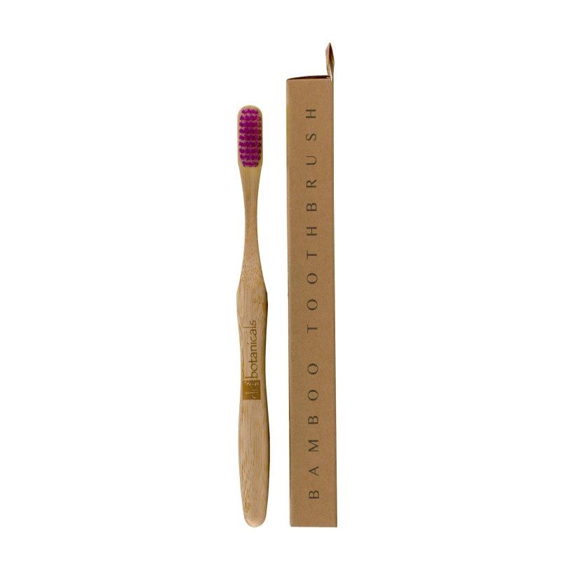 A bamboo toothbrush with purple bristles next to its brown cardboard packaging box on a white background.