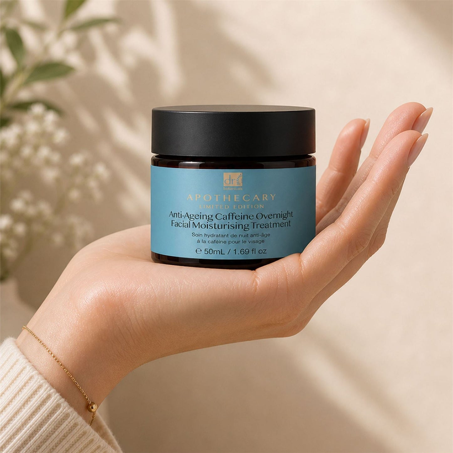 Hand holding a jar of facial moisturizing treatment with a blurred natural background