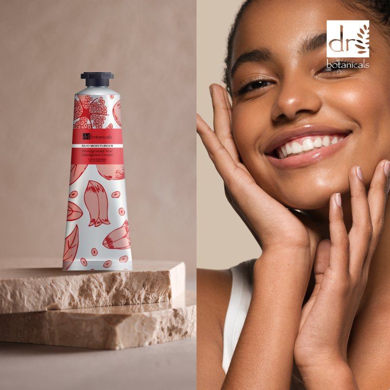 Dr Botanicals Pomegranate Noir Indulgence Cream with red label and pattern next to a woman with smooth skin, featuring Dr Botanicals logo.