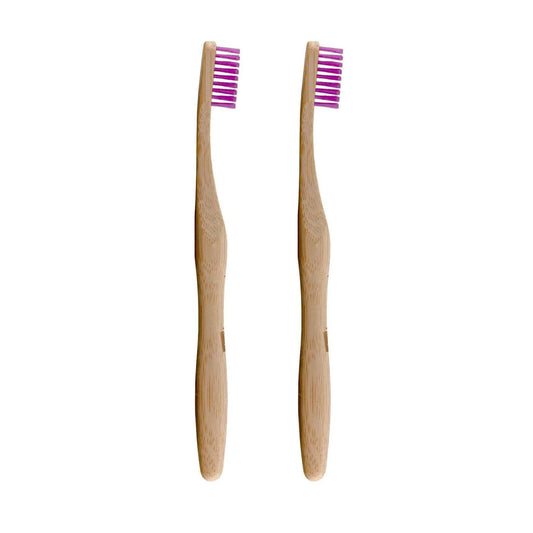 Two bamboo toothbrushes with pink bristles on a white background