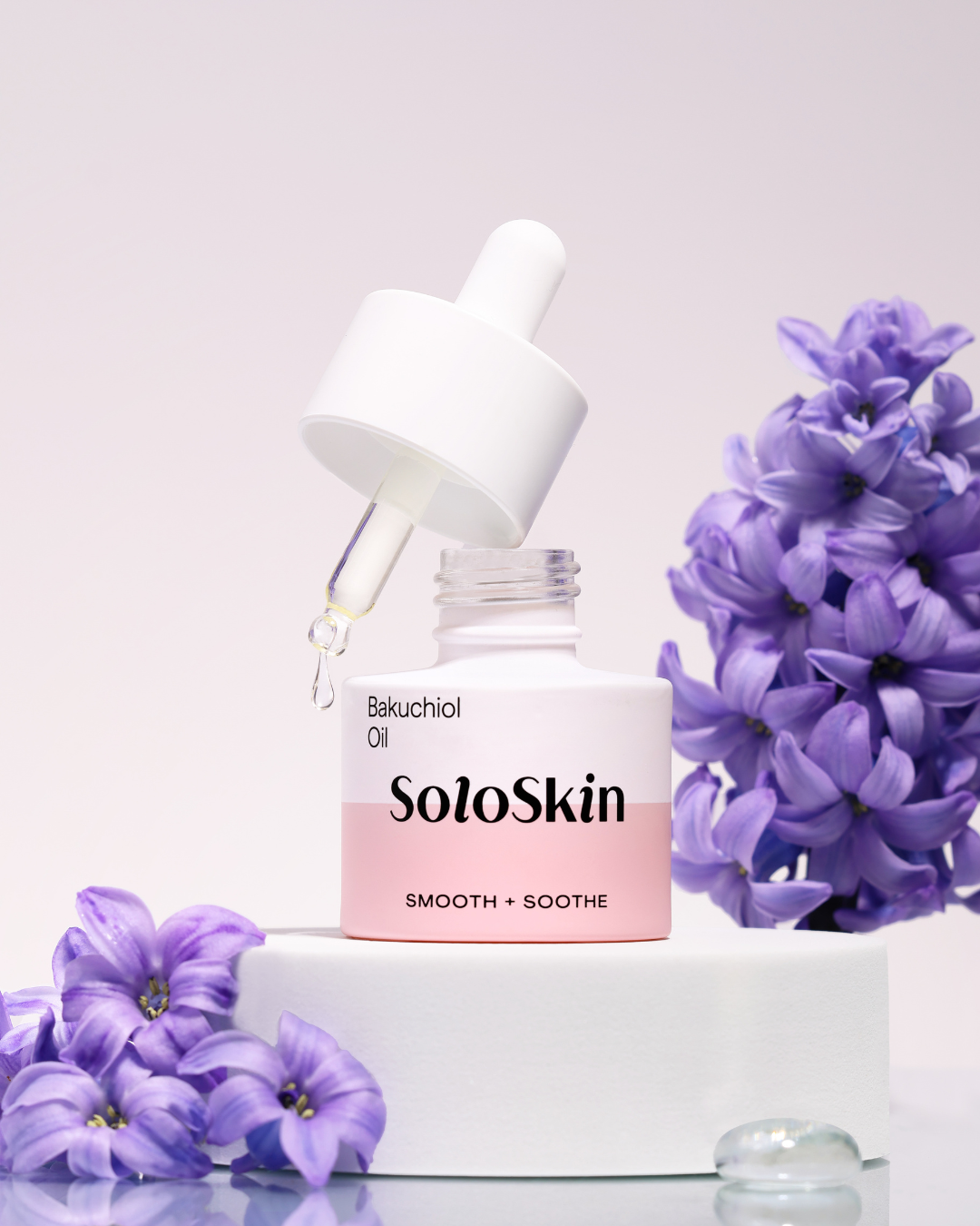 SoloSkin skincare bottle with purple flowers on a light background