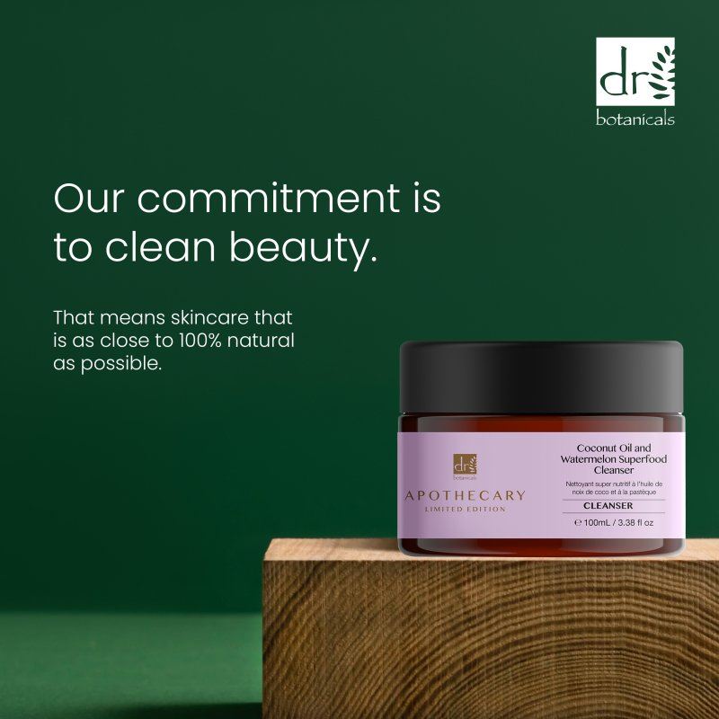 Jar of skincare product with Dr Botanicals branding on a wooden block against a green background.