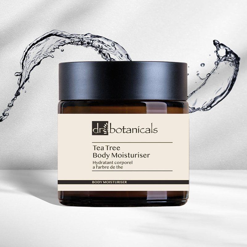 Jar of Dr. Botanicals Tea Tree Body Moisturizer with water splashes on a light background