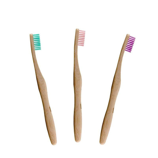 Three bamboo toothbrushes with coloured bristles on a white background