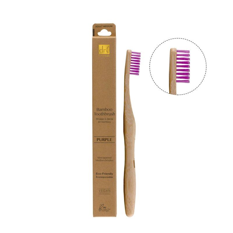 Bamboo toothbrush with purple bristles and packaging on a white background