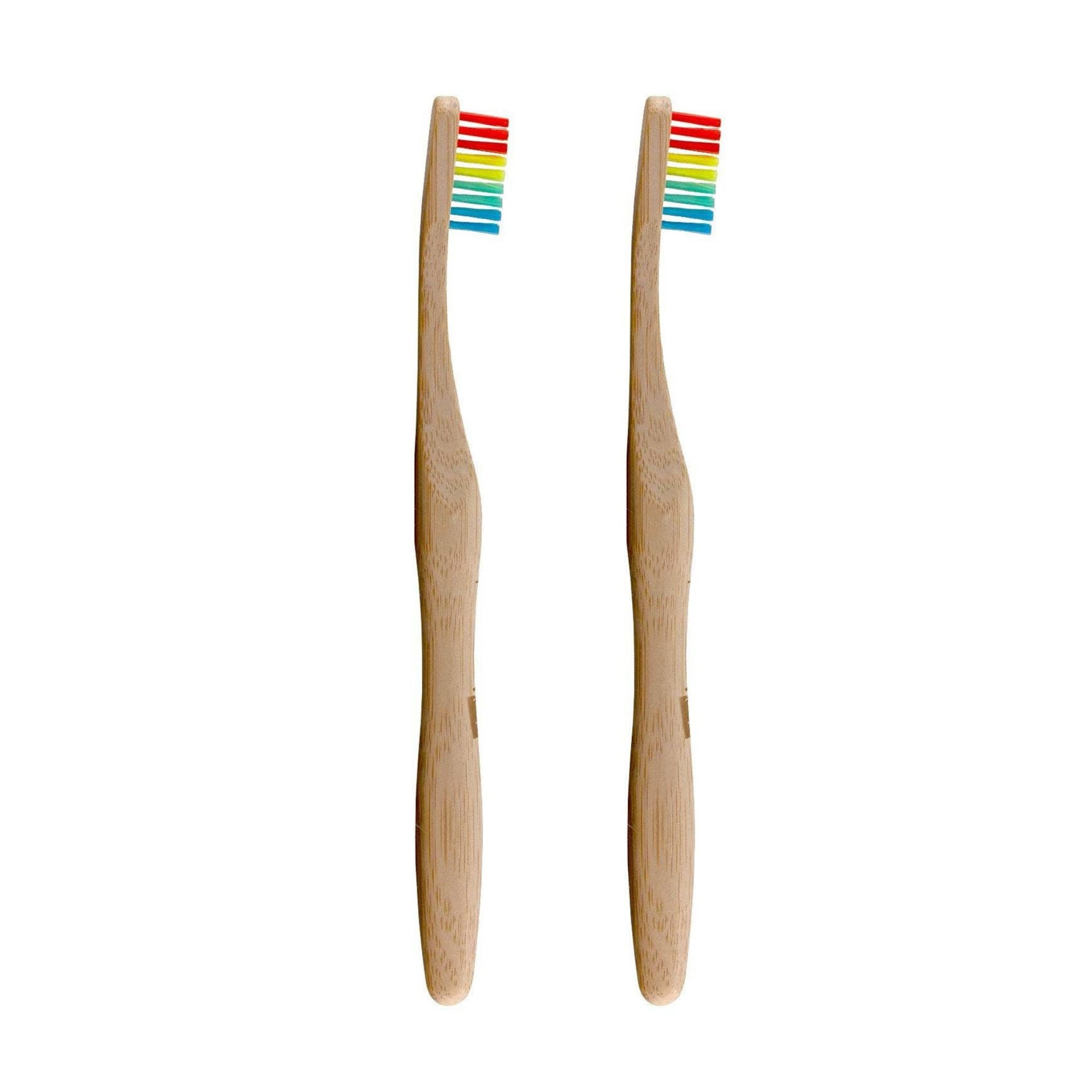 Two bamboo toothbrushes with rainbow bristles on a white background