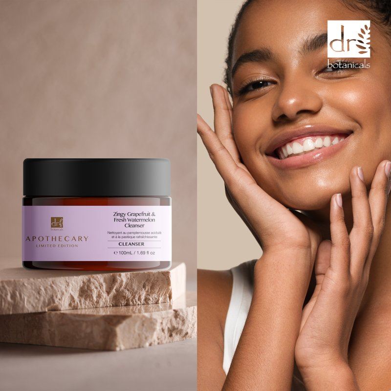 Skincare product jar with a woman touching her face, featuring Dr Botanicals branding.