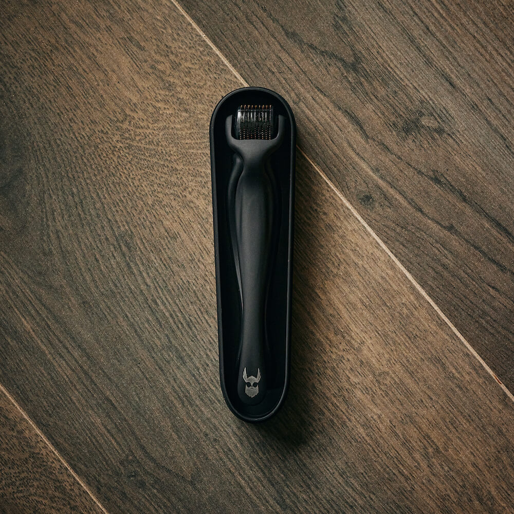 Man using derma roller on beard area