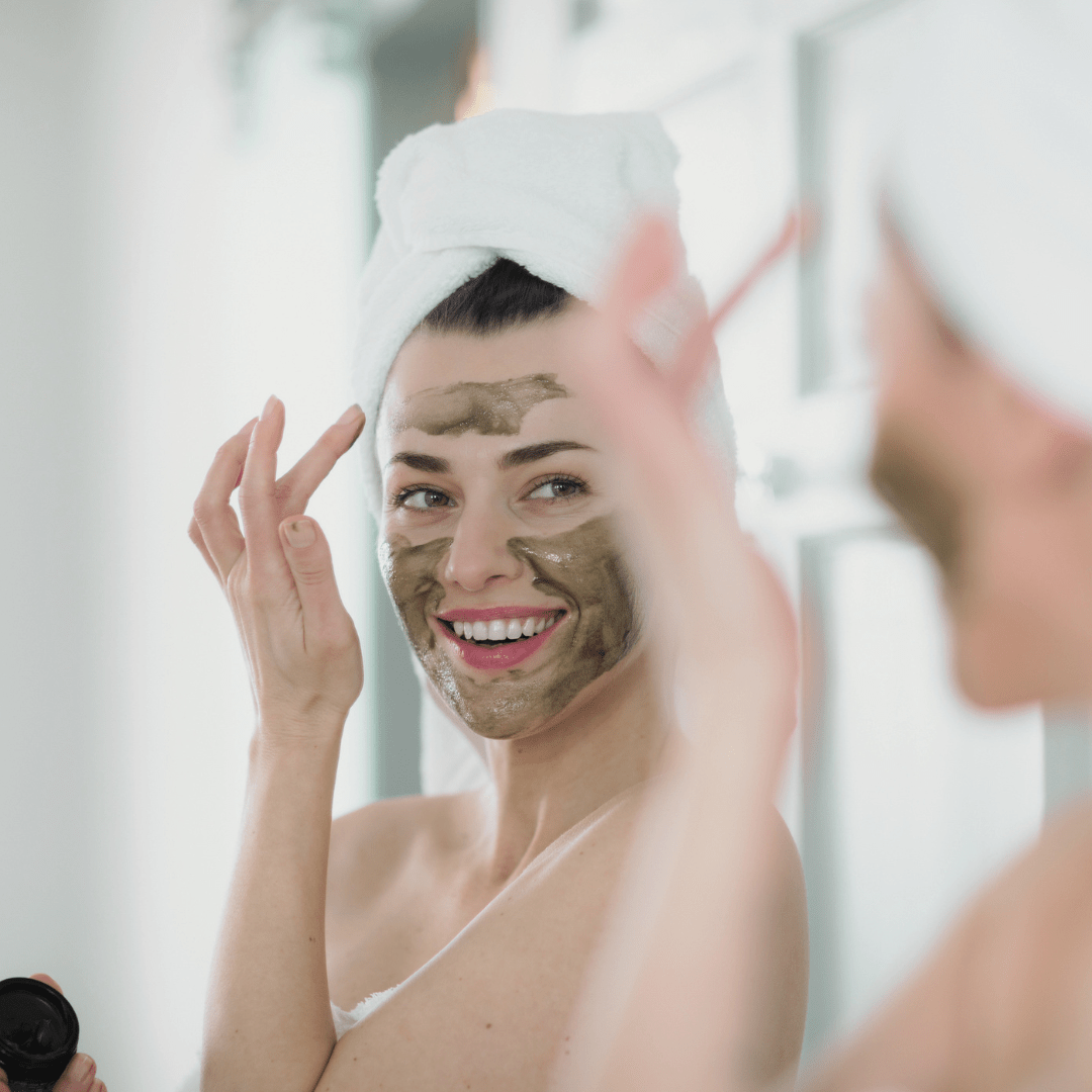 Woman applying Inlight Beauty Super-Food Mask 25ml in front of a mirror