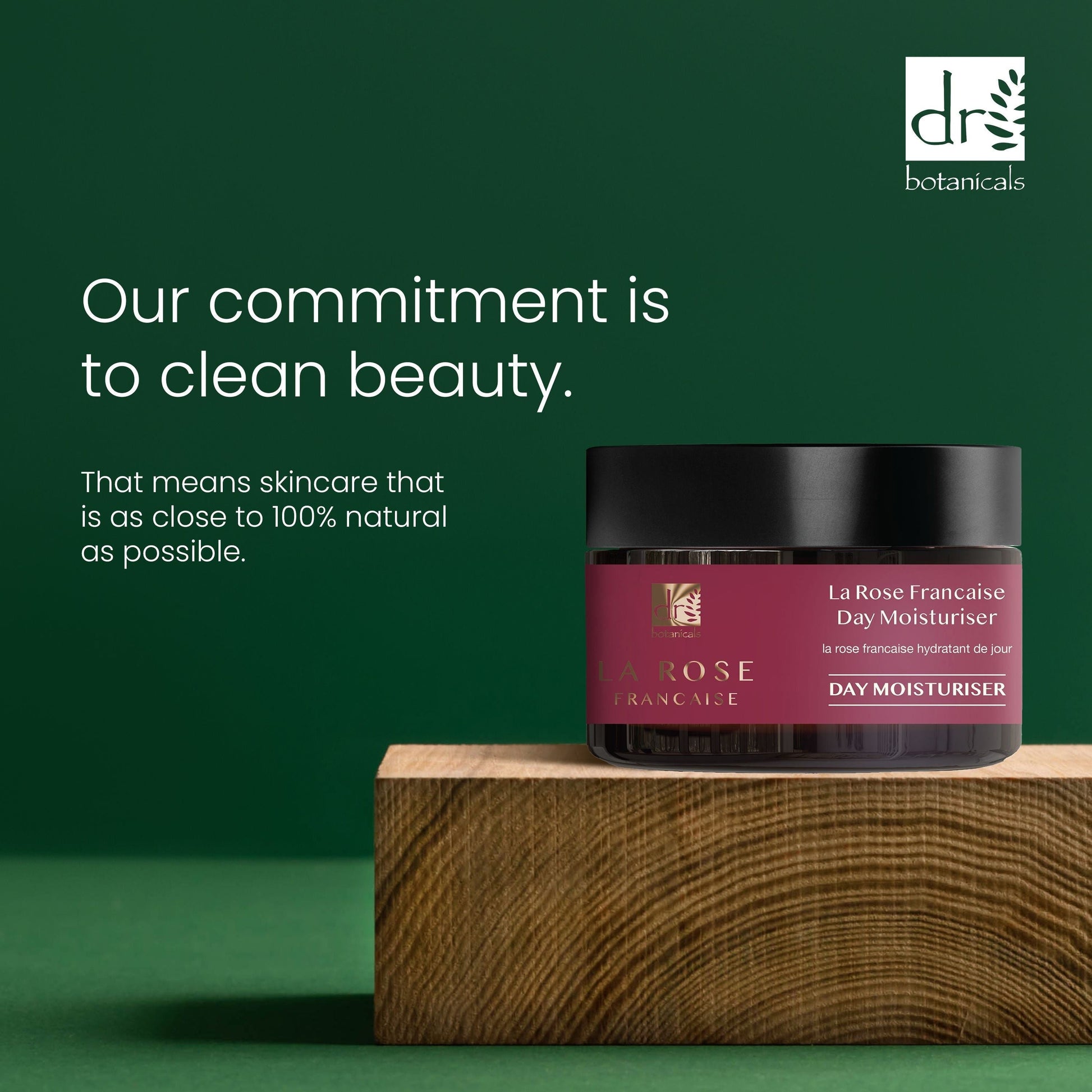 LaRose Française day moisturizer jar on a wooden block with a green background and Dr Botanicals branding.