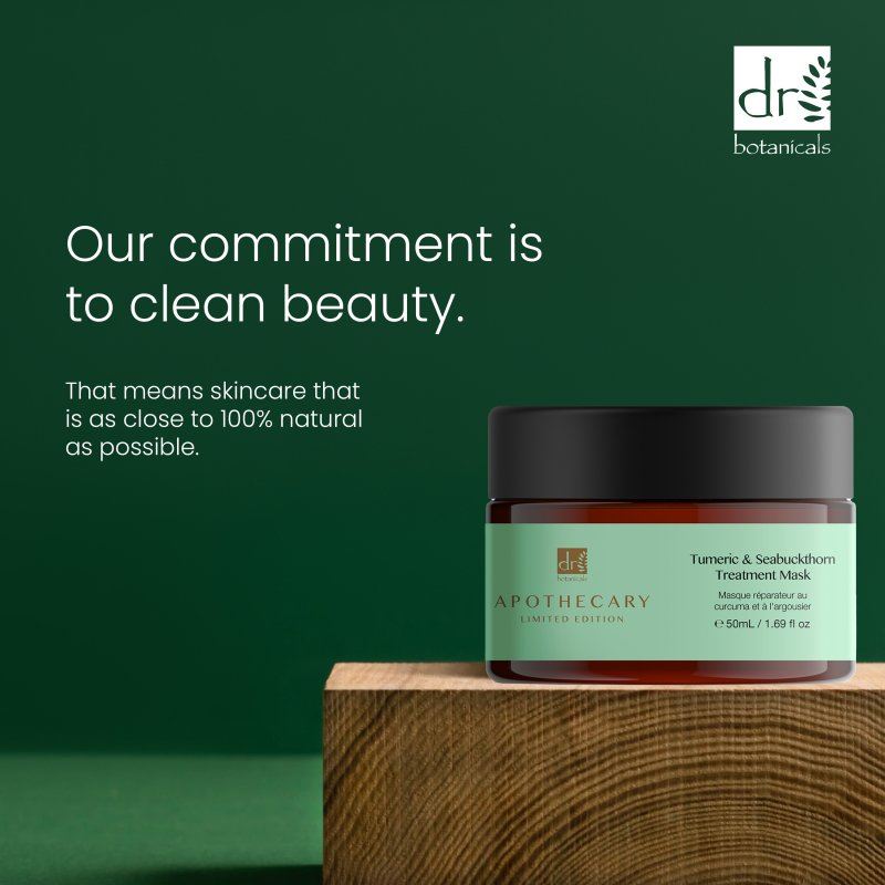 Skincare jar with green label on wooden block against a green background, featuring Dr Botanicals branding.