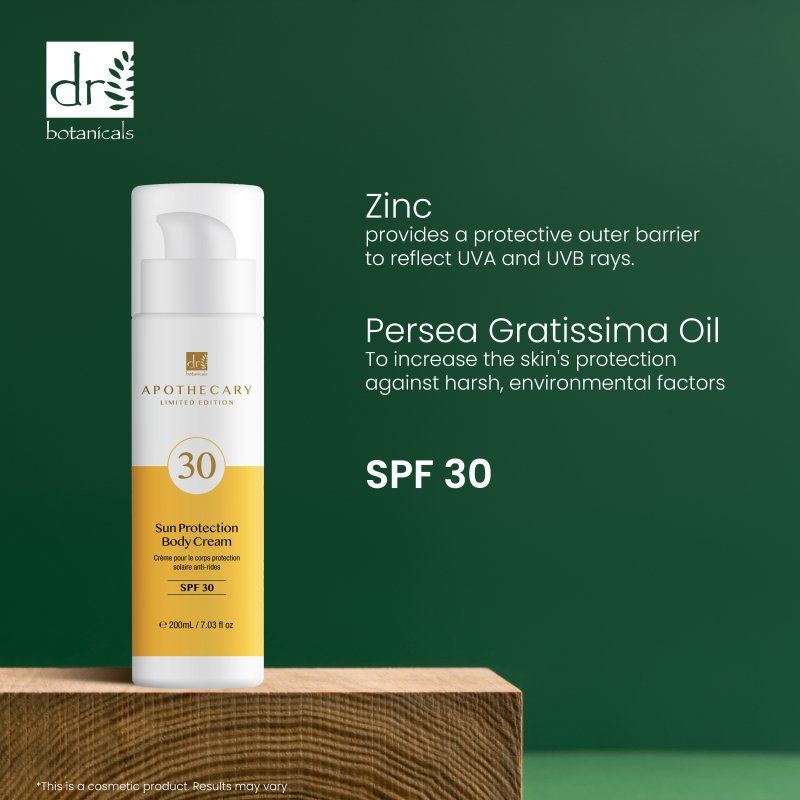 Sun protection body cream with SPF 30 on a wooden block against a green background