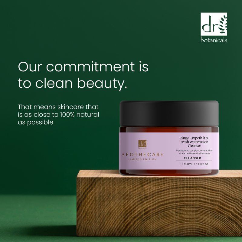 Skincare jar with text about clean beauty on a green background