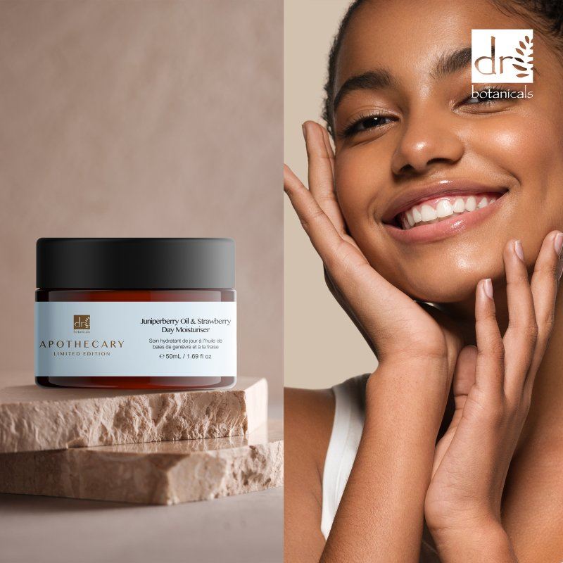 Jar of Apothecary skincare product on a stone surface with a woman touching her face.