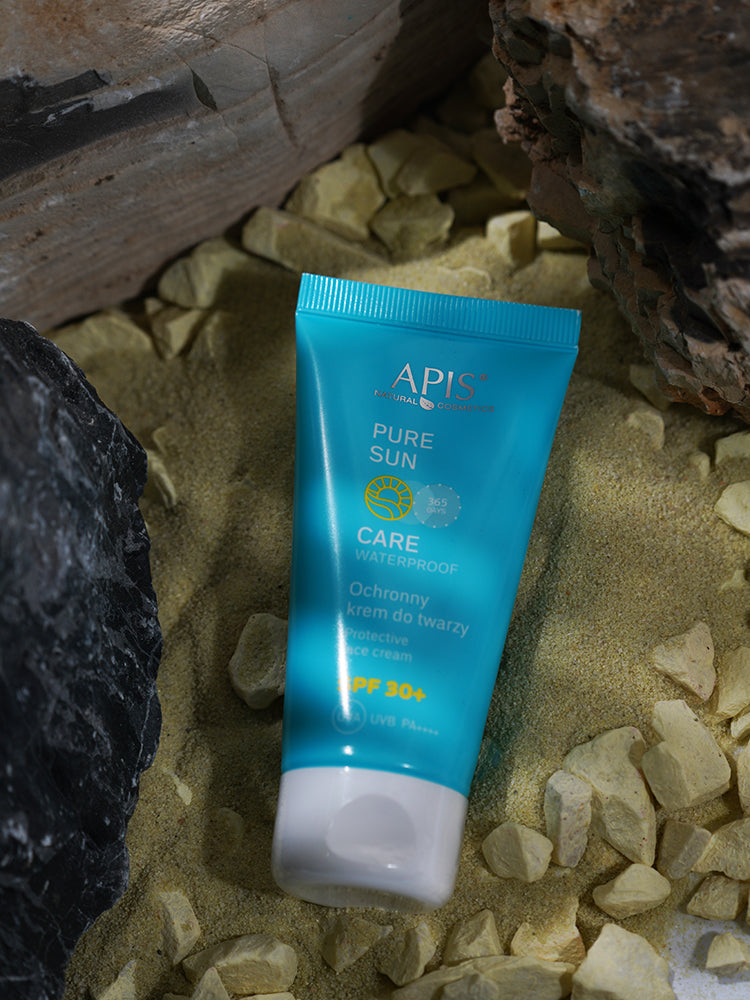 Blue tube of APIS sunscreen on a stone surface