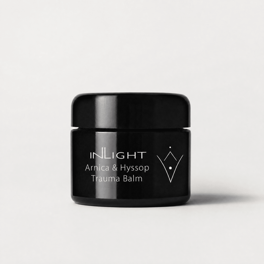 Black jar of Inlight Beauty Arnica & Hyssop Trauma Balm 45ml on a light grey background
