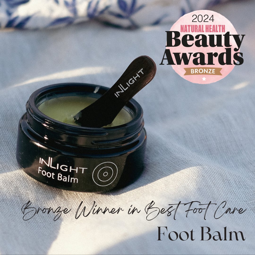 Inlight Beauty Foot Balm 45ml jar with a wooden applicator on a textured surface, featuring 2024 Natural Health Beauty Awards bronze badge.