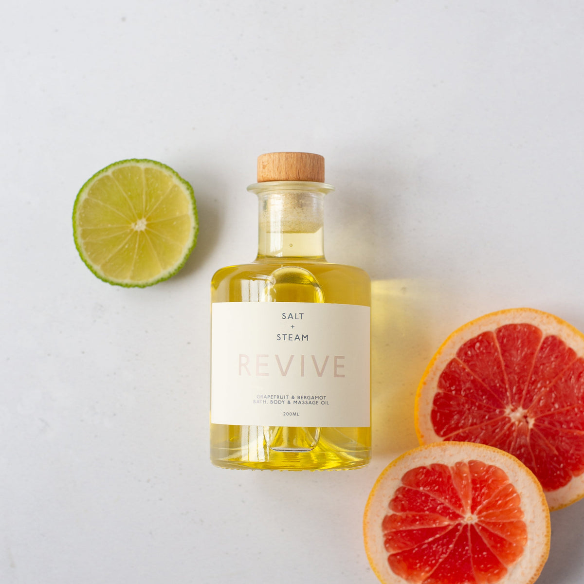 Salt + Steam Revive grapefruit and bergamot bath oil bottle