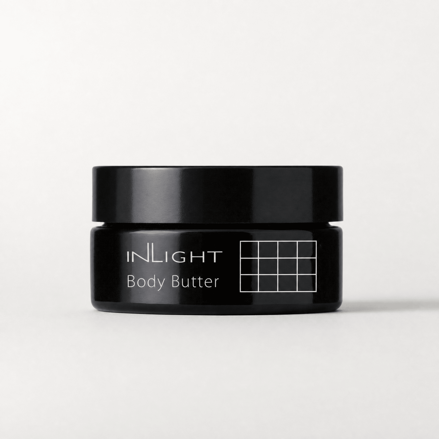 Black jar of Inlight Beauty Body Butter 90ml on a white background