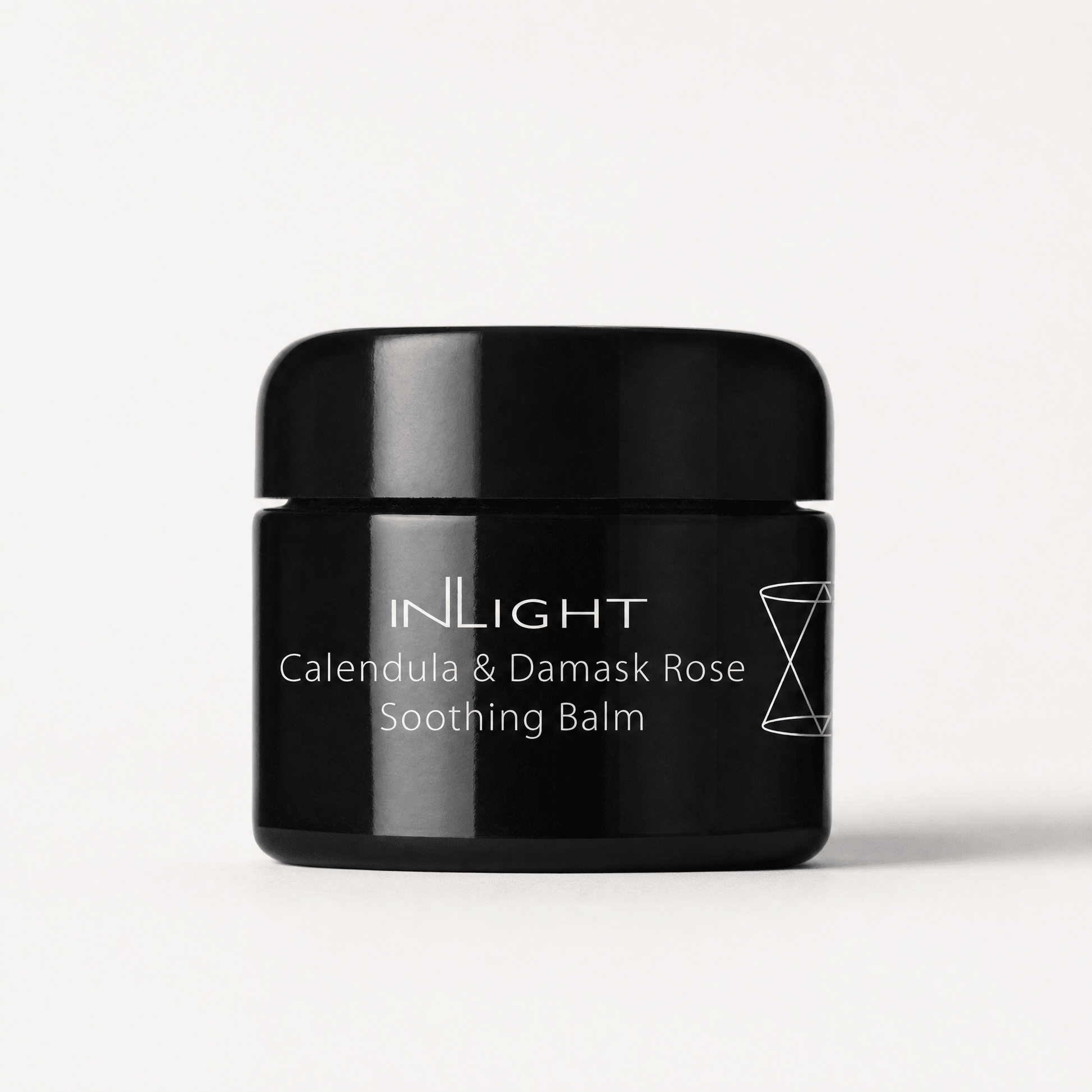 Black jar of Inlight Beauty Calendula & Damask Rose Soothing Balm 45ml on a white background