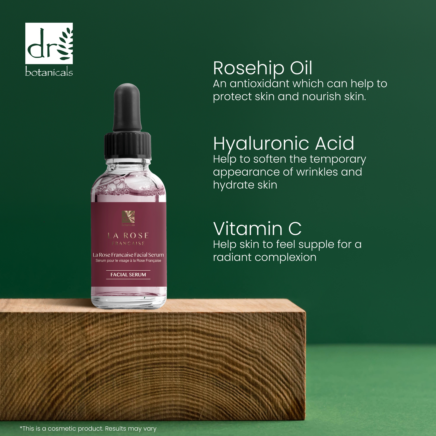 Facial serum bottle with dropper on a wooden block against a green background, featuring text about rosehip oil, hyaluronic acid, and vitamin C benefits.