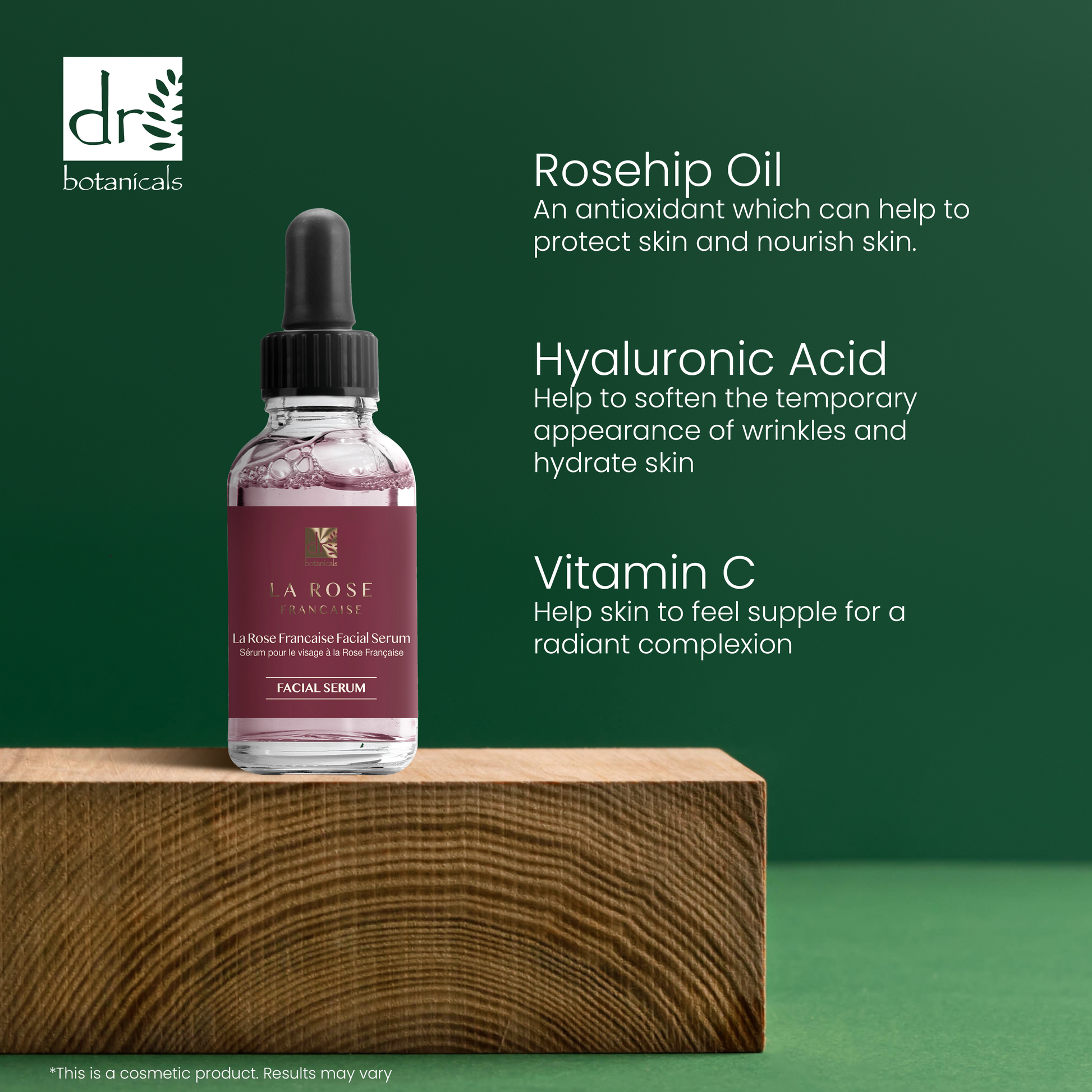 Facial serum bottle with dropper on a wooden block against a green background, featuring text about rosehip oil, hyaluronic acid, and vitamin C benefits.