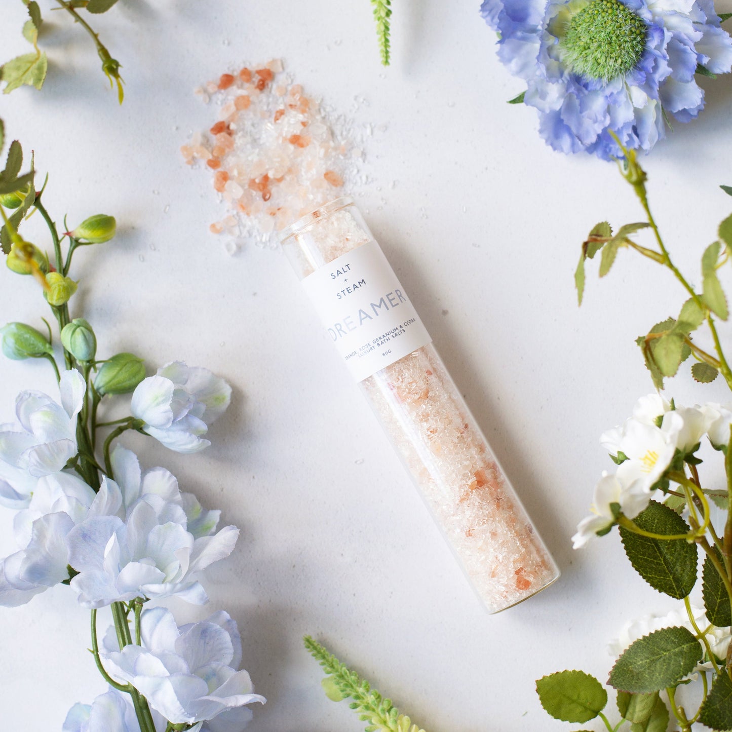 Salt + Steam Flower Power bath salts being poured into a bath