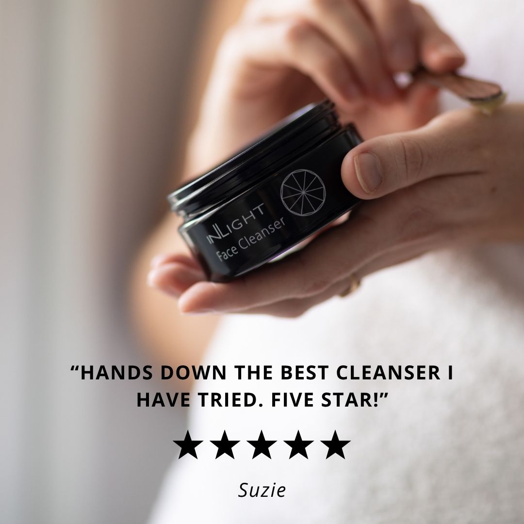 Person holding a black jar of Inlight Beauty Face Cleanser with a five-star rating and review quote.
