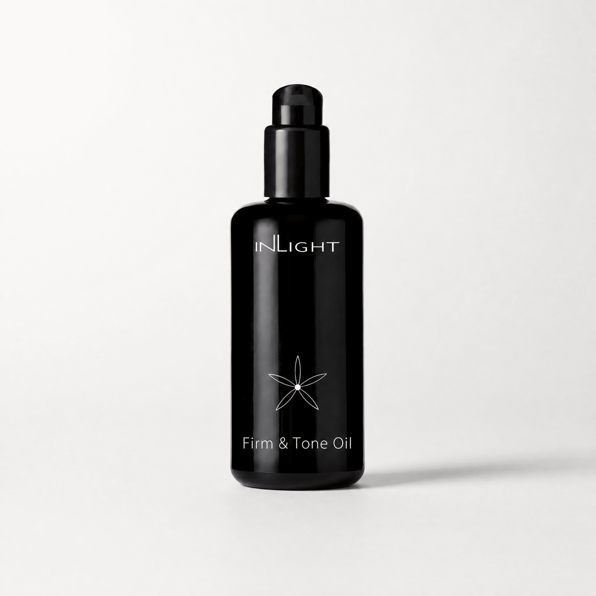 Black bottle of Inlight Beauty Firm & Tone Oil 200ml on a white background