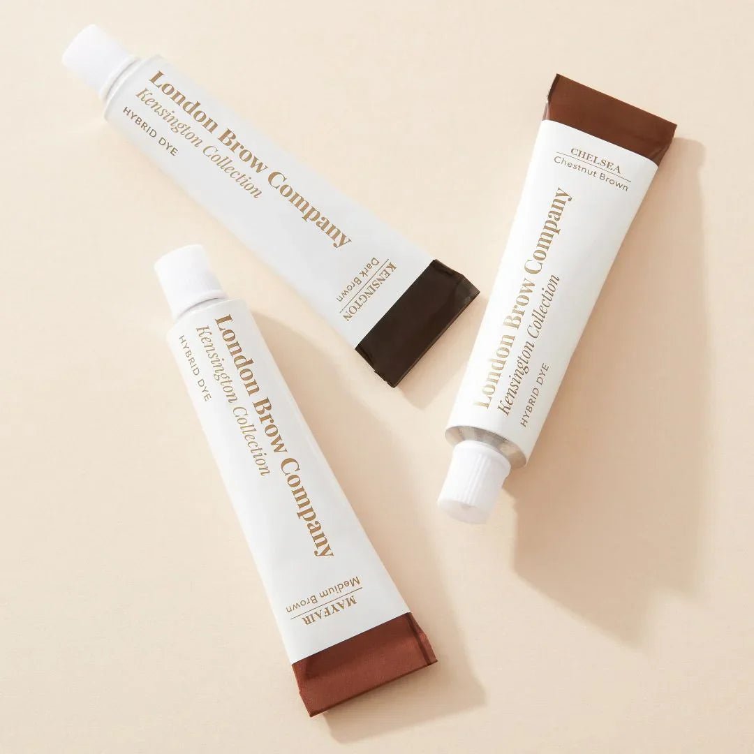 Three tubes of London Brow Company eyebrow products on a beige background