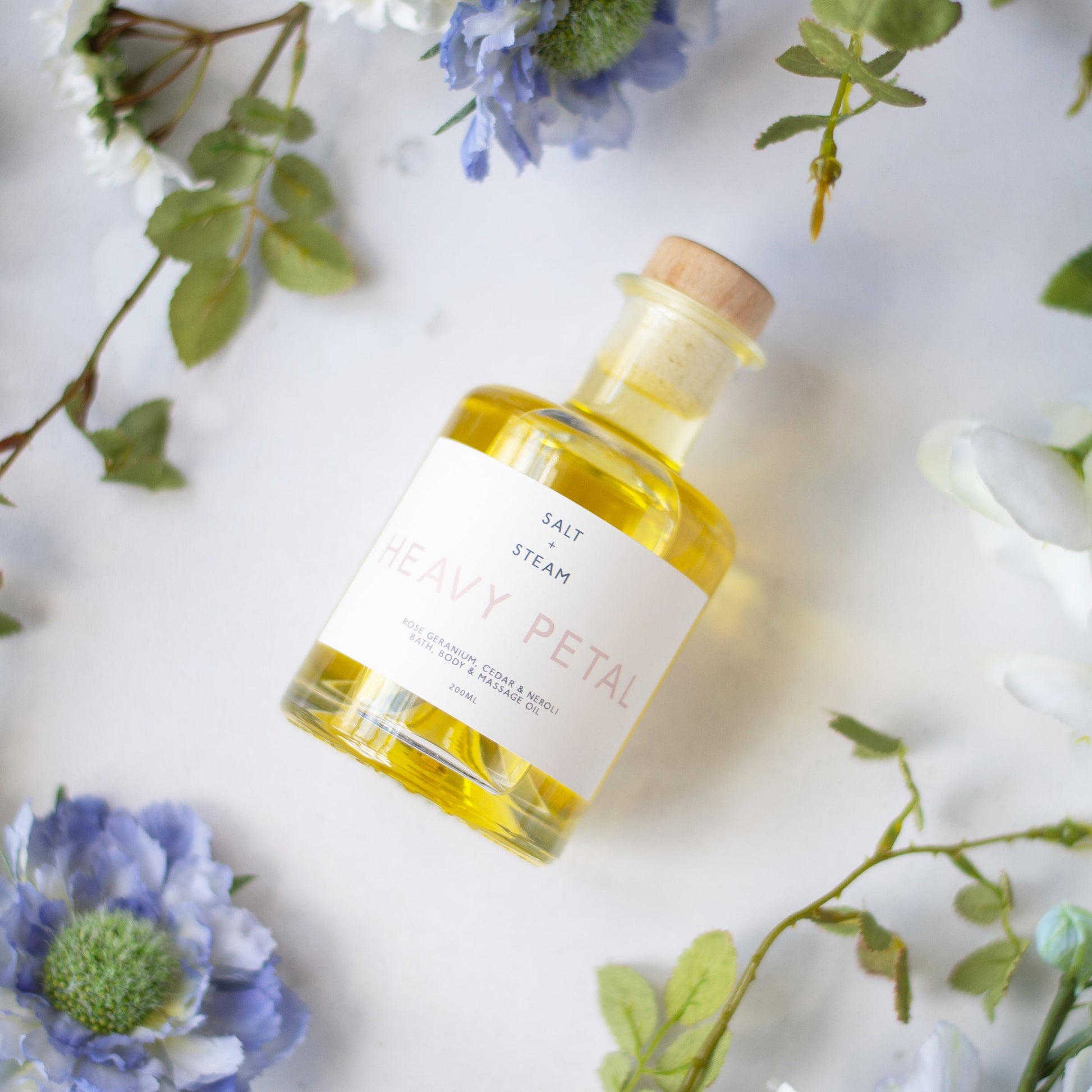 Salt + Steam bath and body oil range including Heavy Petal
