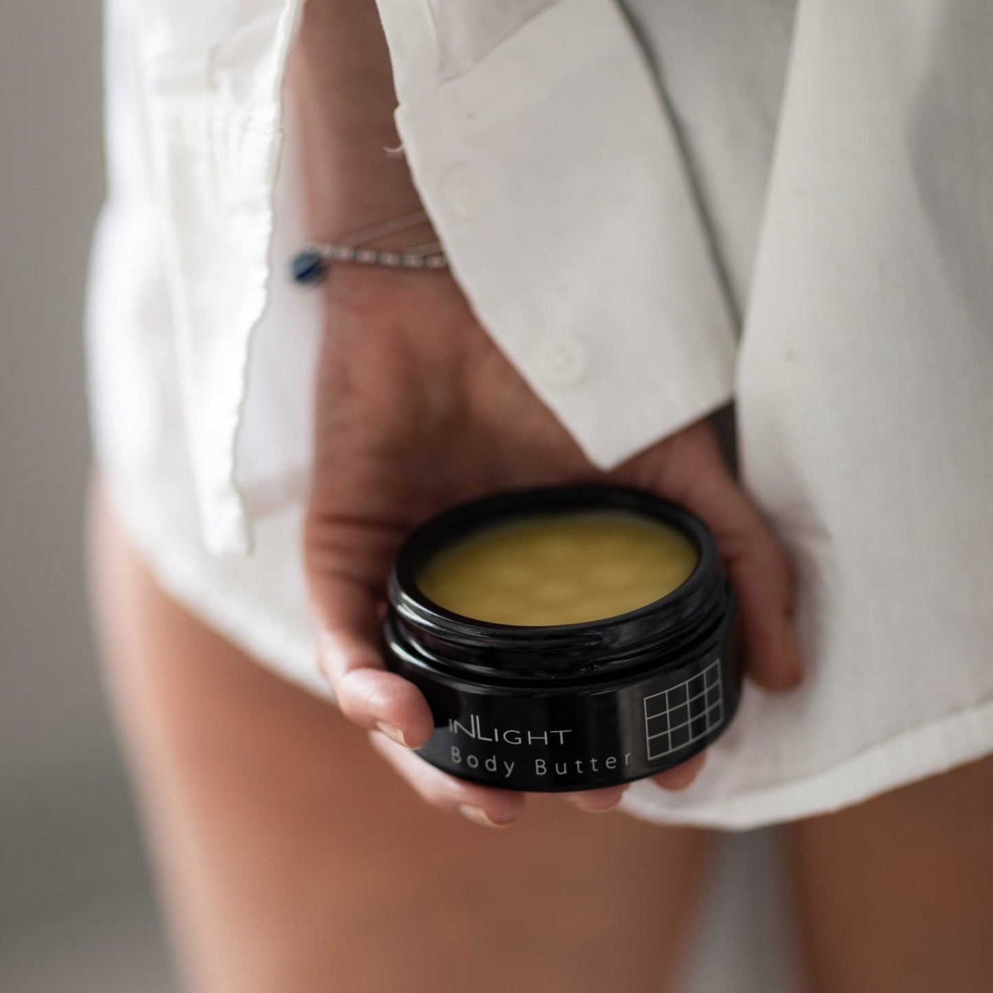 Person holding a container of Inlight Beauty Body Butter 90ml