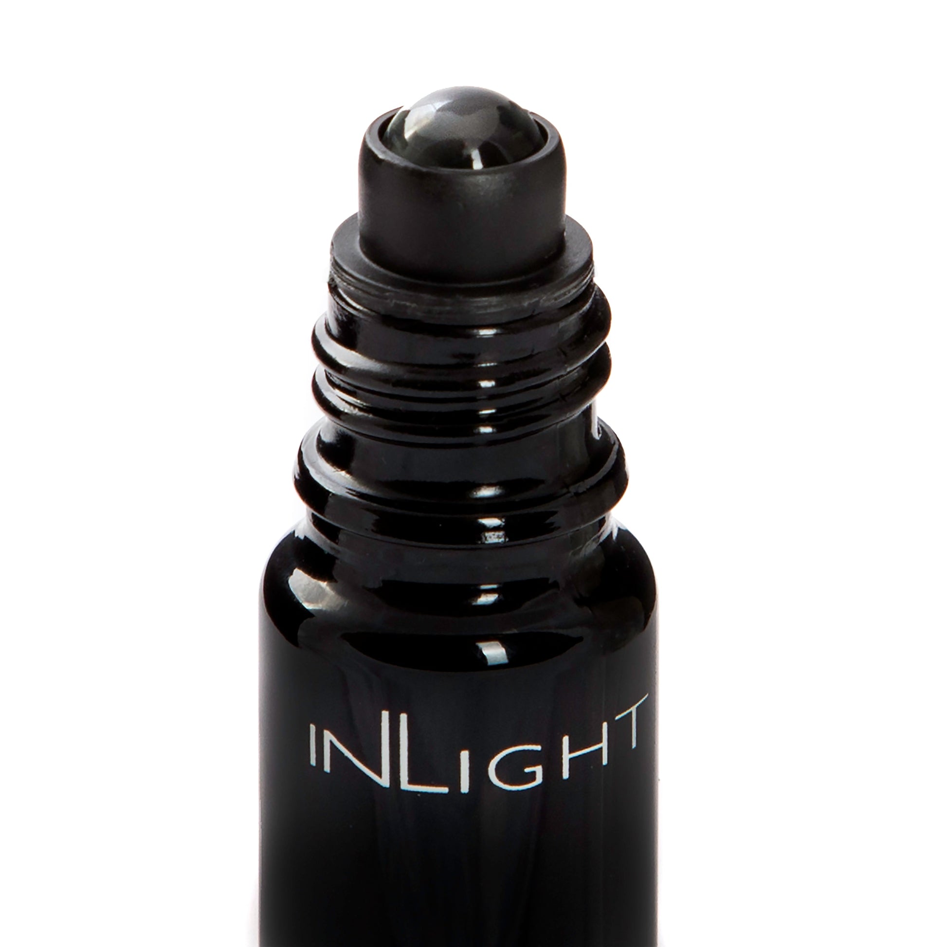 A close-up of a black glass roller bottle with a black roller ball applicator, featuring the brand name 'INLIGHT' printed in white on the front, set against a plain white background.