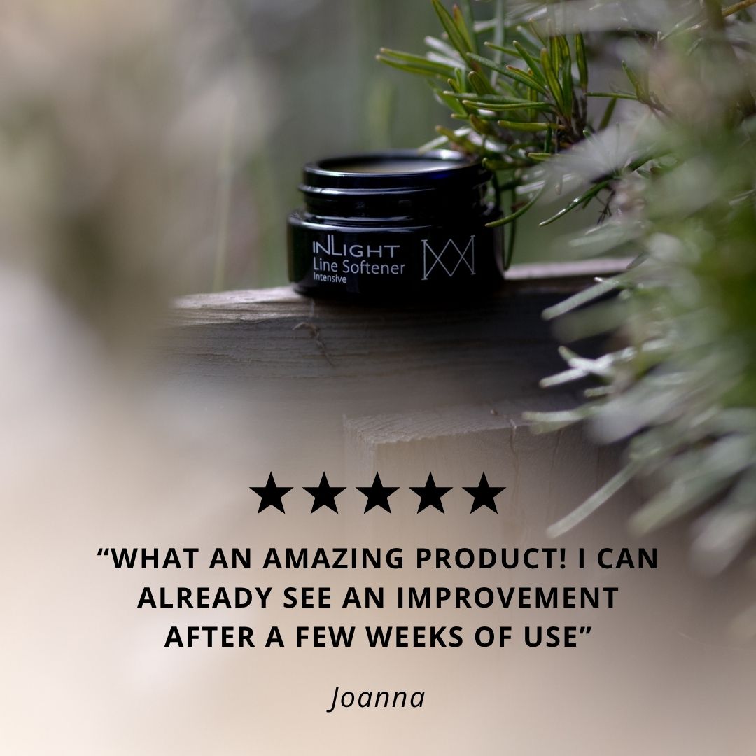 Two black jars labeled Inlight Beauty Line Softener Intensive 15ml on a wooden surface with greenery in the background.