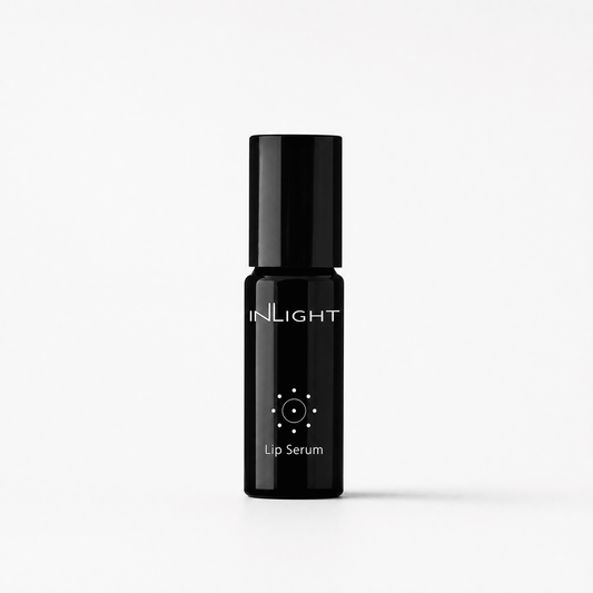 A black cylindrical lip serum bottle with a matching black cap, featuring the brand name 'INLIGHT' and 'Lip Serum' printed in white on the front, set against a clean white background.
