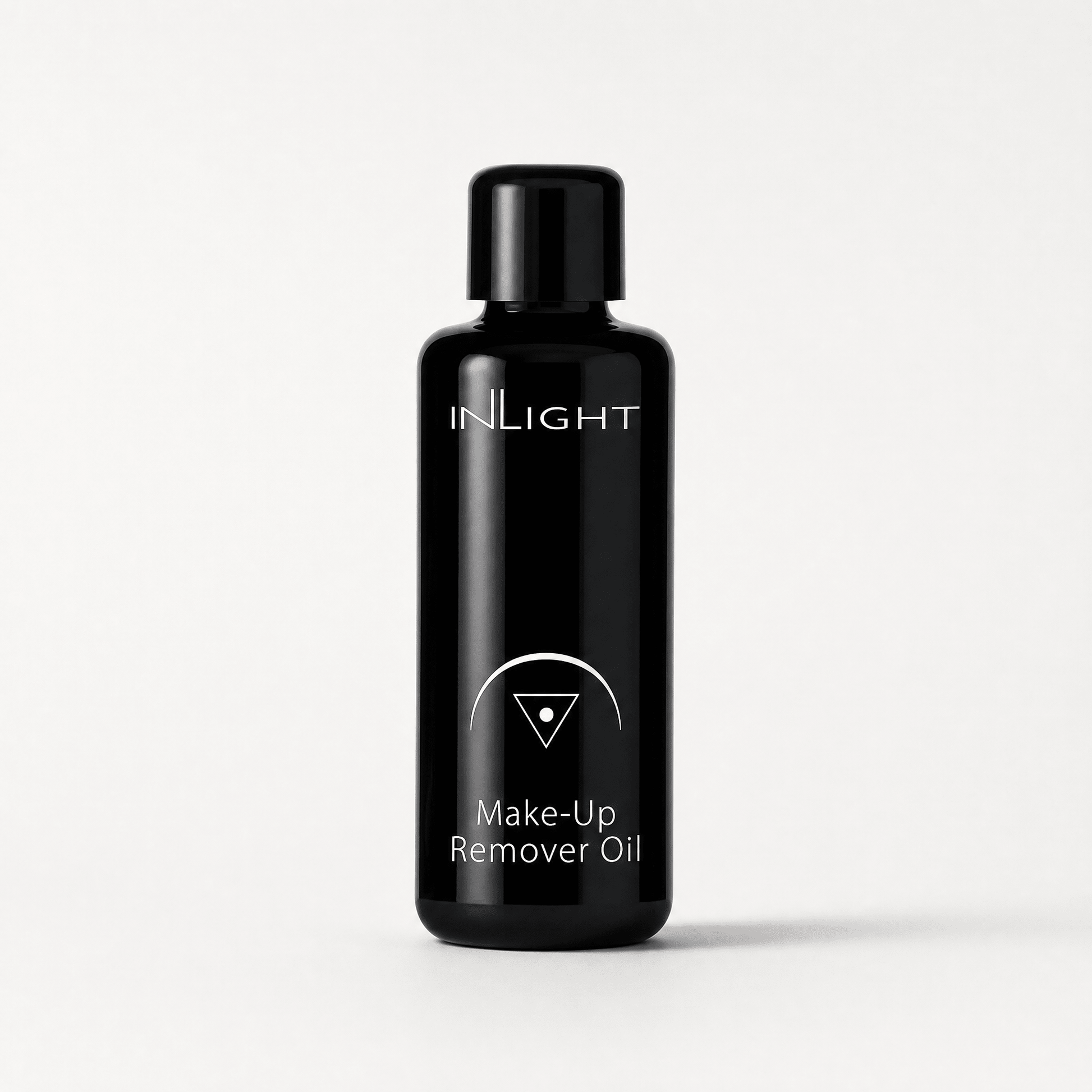 Black bottle of Inlight Beauty Make-up Remover Oil 50ml on a white background
